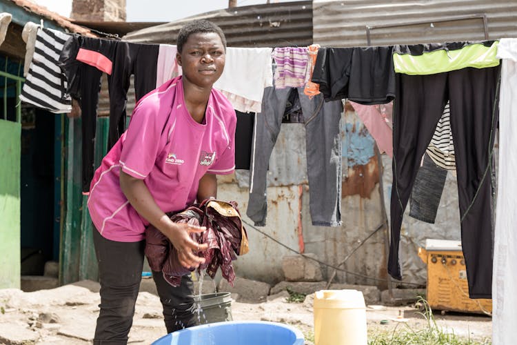 Girl Washing Clothes In A Basin