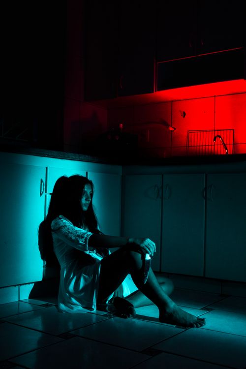 Free Emotional scene of a woman in moody lighting, evoking horror and suspense. Stock Photo
