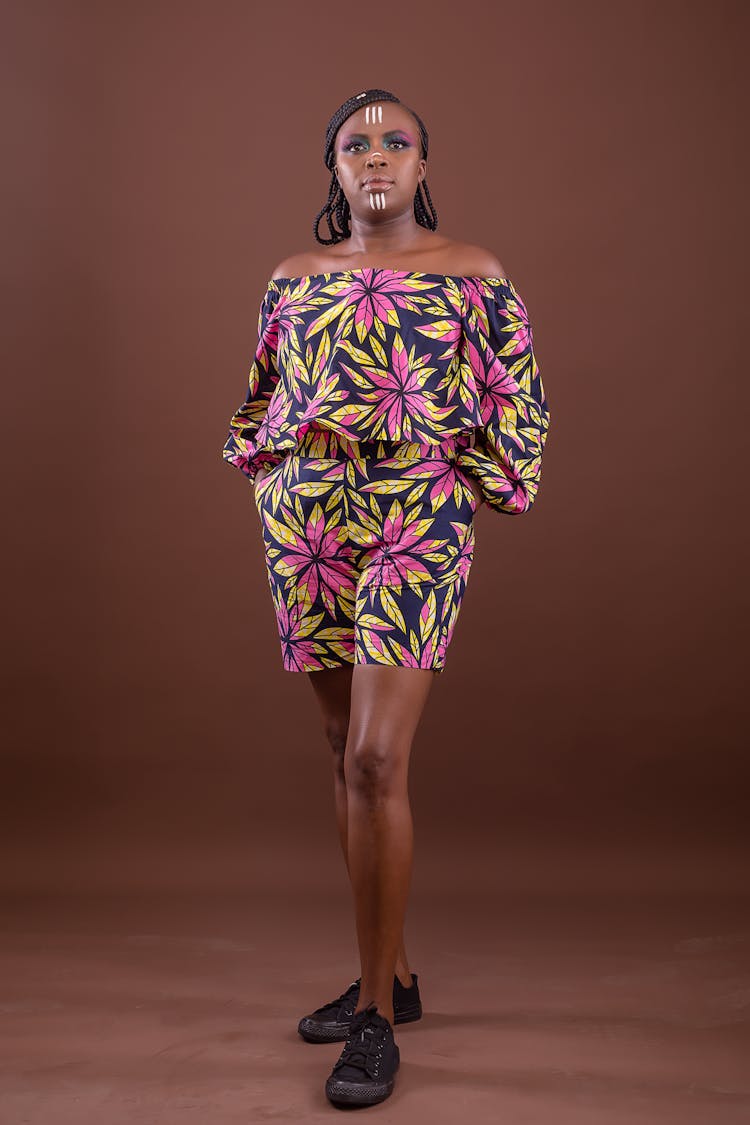 Studio Portrait Of A Woman In A Floral Dress And With A Tribal Face Paint