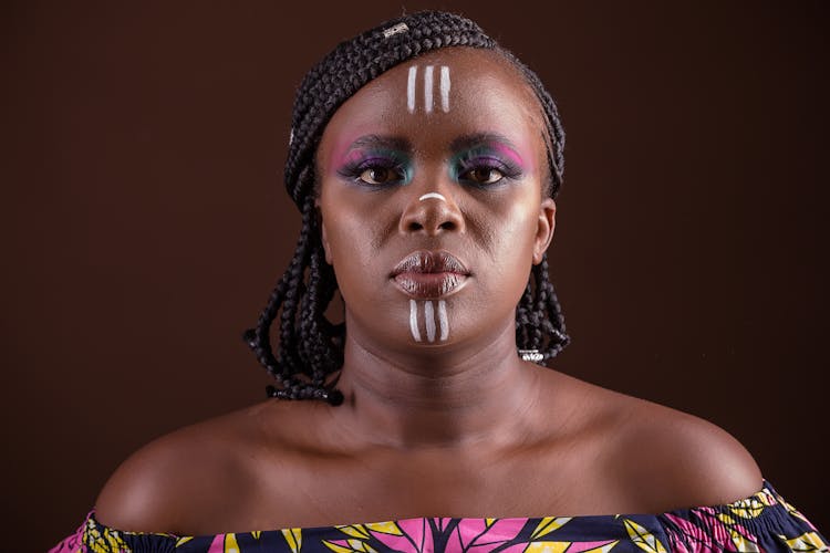 Studio Portrait Of A Woman With A Tribal Face Paint