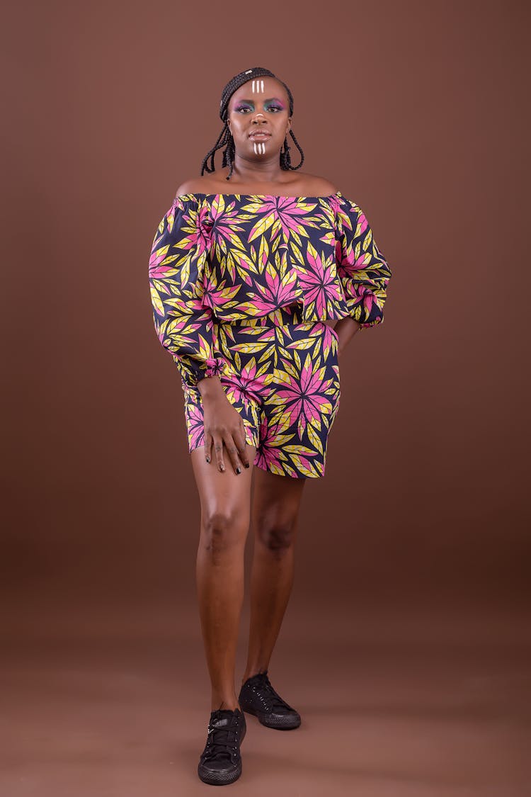 Studio Portrait Of A Woman In A Floral Dress And With A Tribal Face Paint