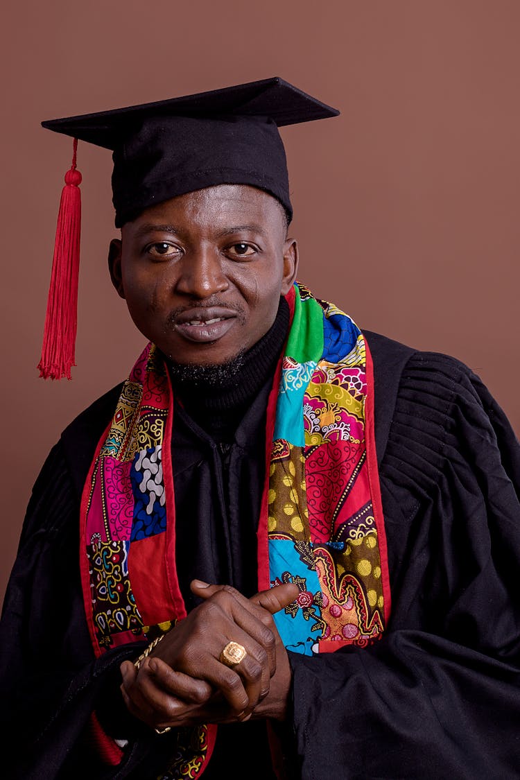 Portrait Of Man In Graduation Mantle And Hat