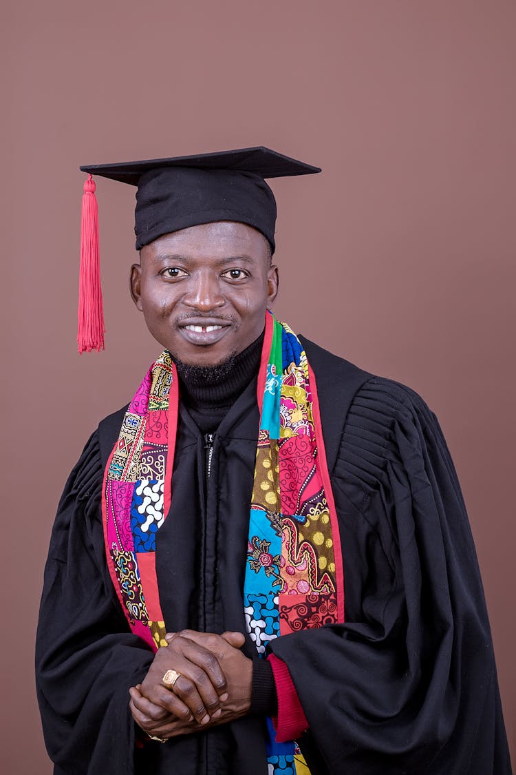 Portrait Of Smiling Man In Graduation Mantle