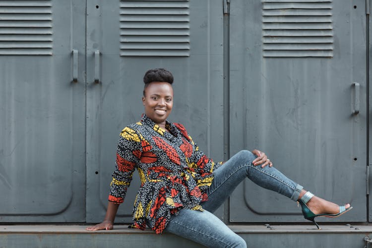 Plus Size Model Posing In Jeans And Elegant Blouse