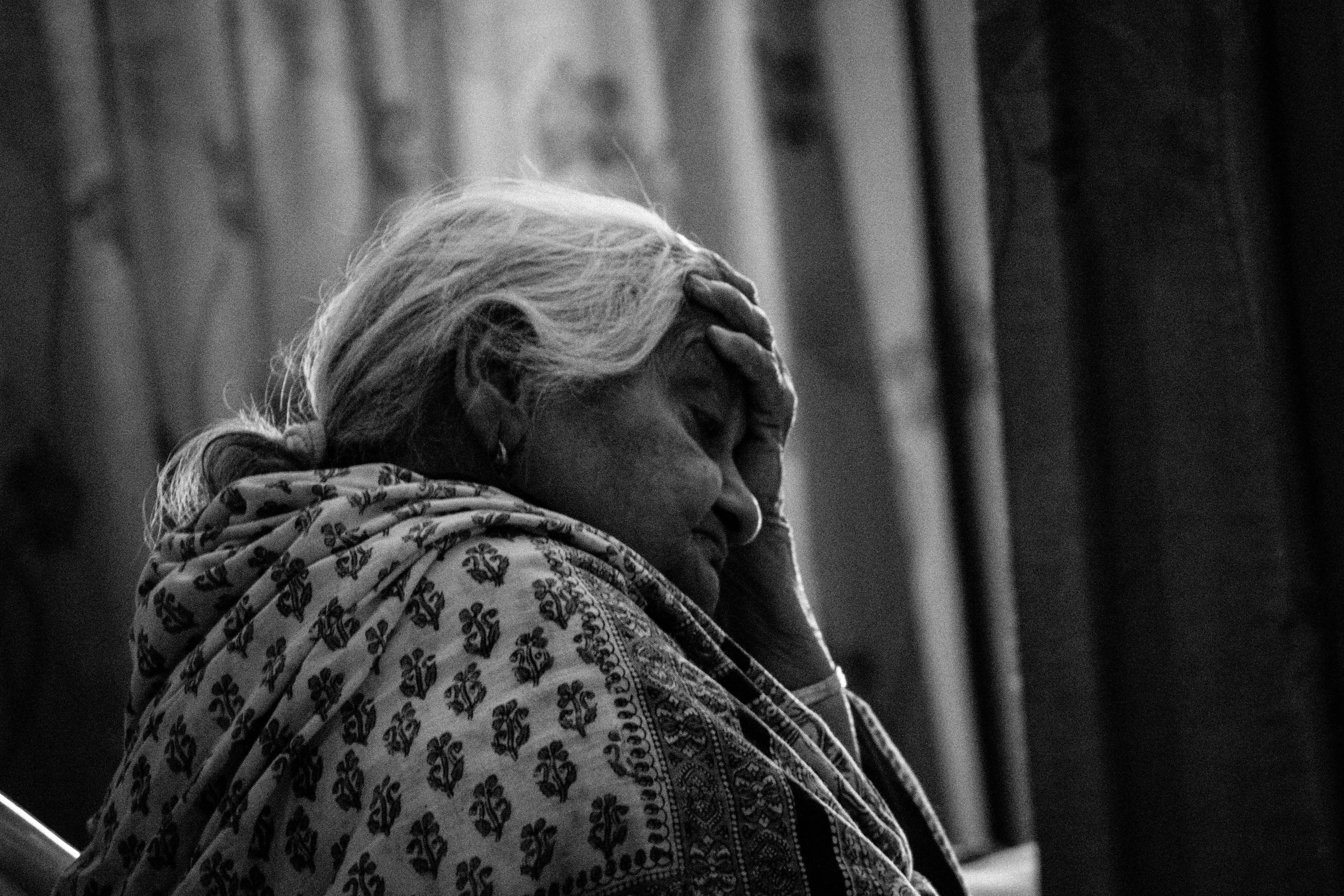 Old woman touching her forehead | Photo: Pexels