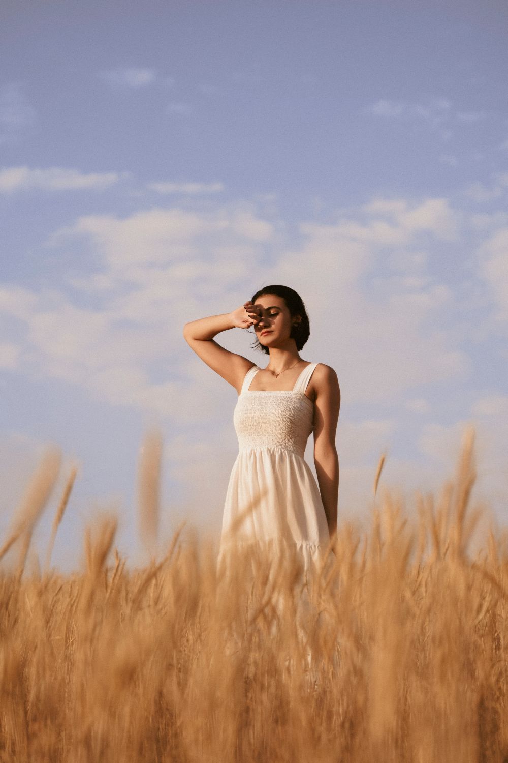 Woman in a White Dress Posing in a Field · Free Stock Photo
