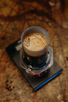 Close-up of a fresh espresso made with an Aeropress showcasing a rich crema, perfect for coffee enthusiasts.