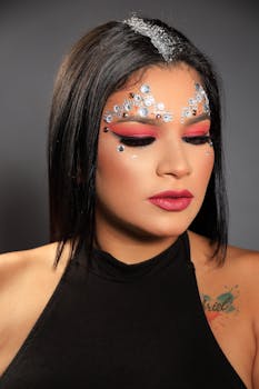 Striking portrait of a woman with creative bead makeup, eyes closed, in a black top.