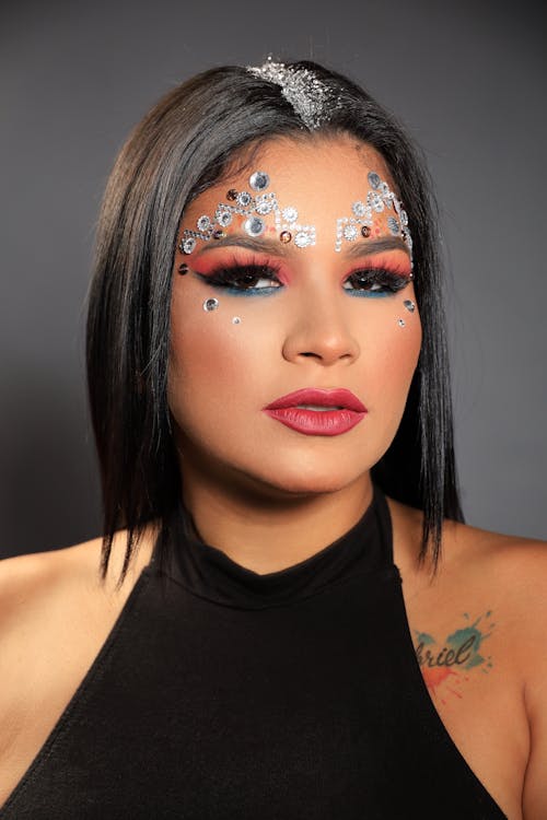 Studio Portrait of a Young Woman Wearing Creative Makeup with Beads 