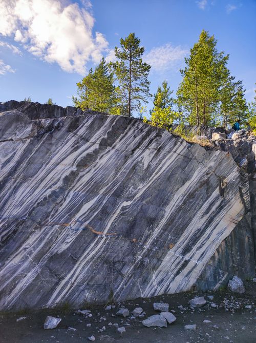 Free Beautiful rock formation with trees under blue sky and clouds. Stock Photo