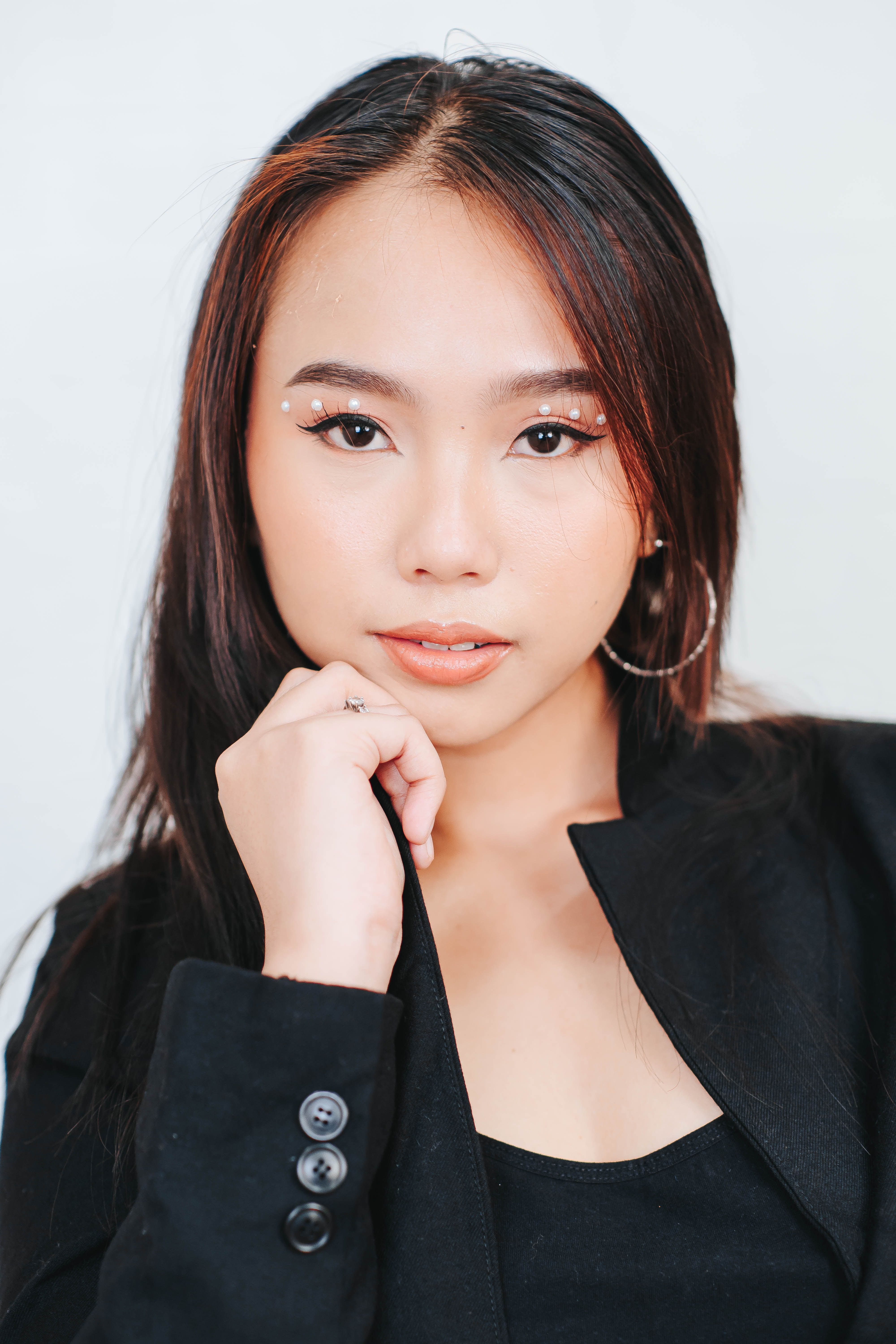 Stylish portrait of an elegant woman posing confidently in a black blazer.