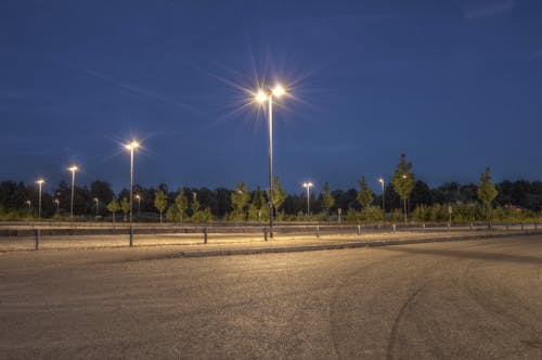 Free Photography of Empty Field With Post Lamps Stock Photo