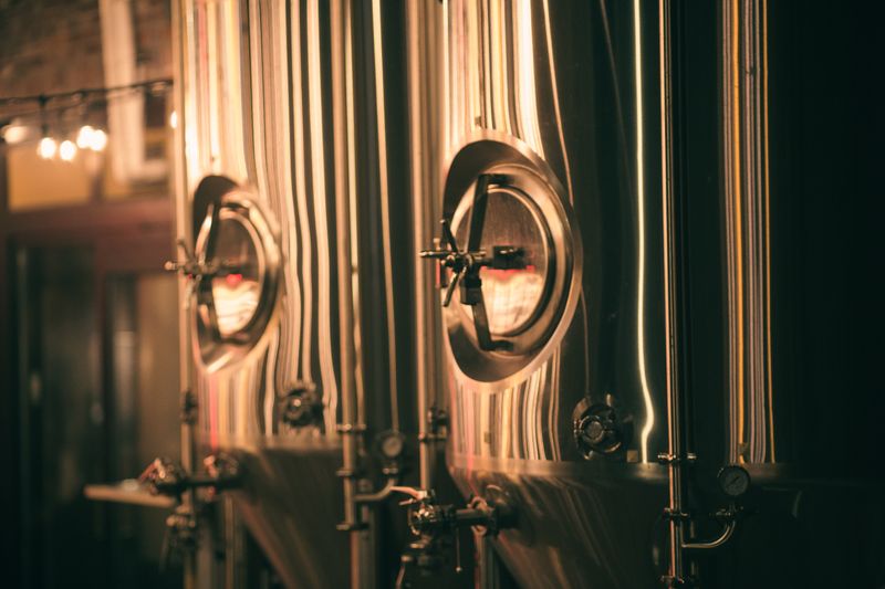 Brewer checking copper tanks at Ironside Brewing Co. in Asheville, North Carolina
