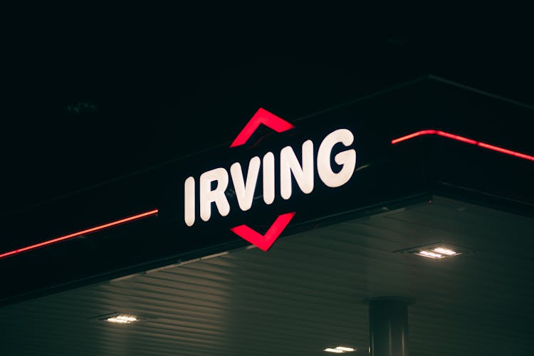 Neon Light Of The Irving Oil Company At The Gas Station At Night