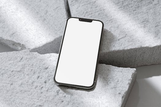 A minimalist smartphone with blank screen on a textured stone background, perfect for mockups.