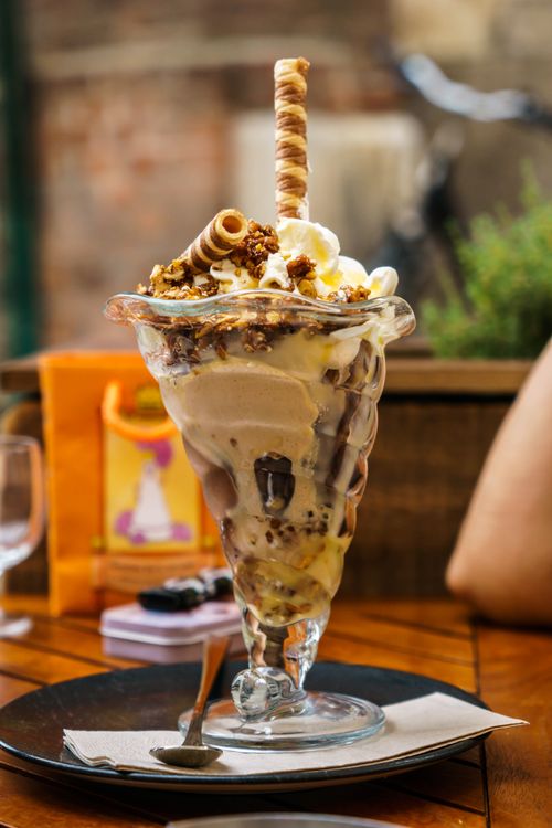 Free Delicious ice cream sundae with toppings served outdoors at a Munich café. Stock Photo