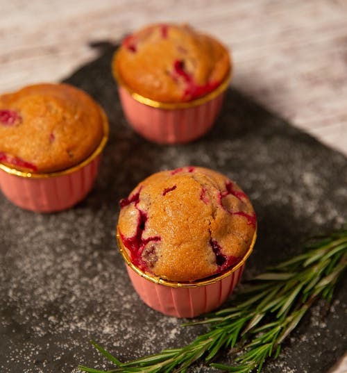 Photo of Three Raspberry Muffins on a Table