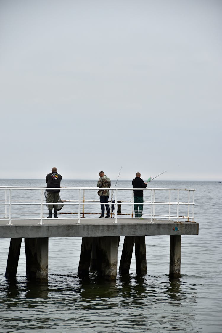 Men Fishing On A Dock