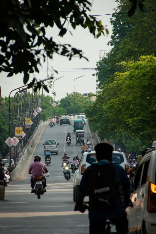 Free A busy street scene in Lucknow, India with cars and motorcycles on the road. Stock Photo