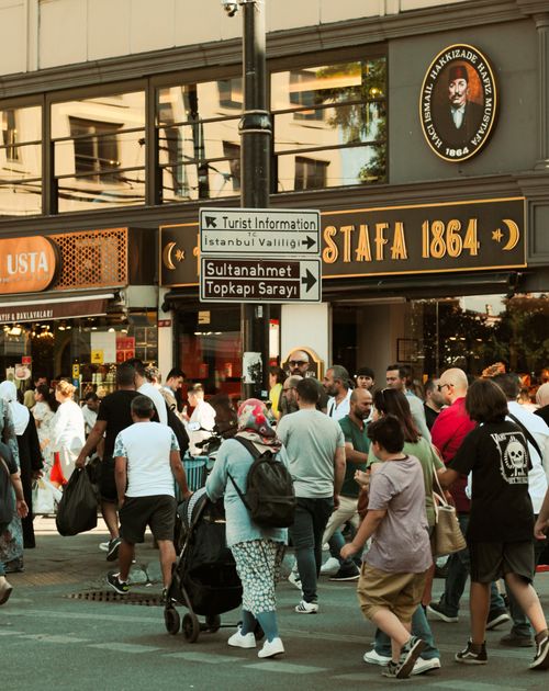 Free A lively street scene in Istanbul with diverse people walking by, vibrant shops, and distinct signage. Stock Photo