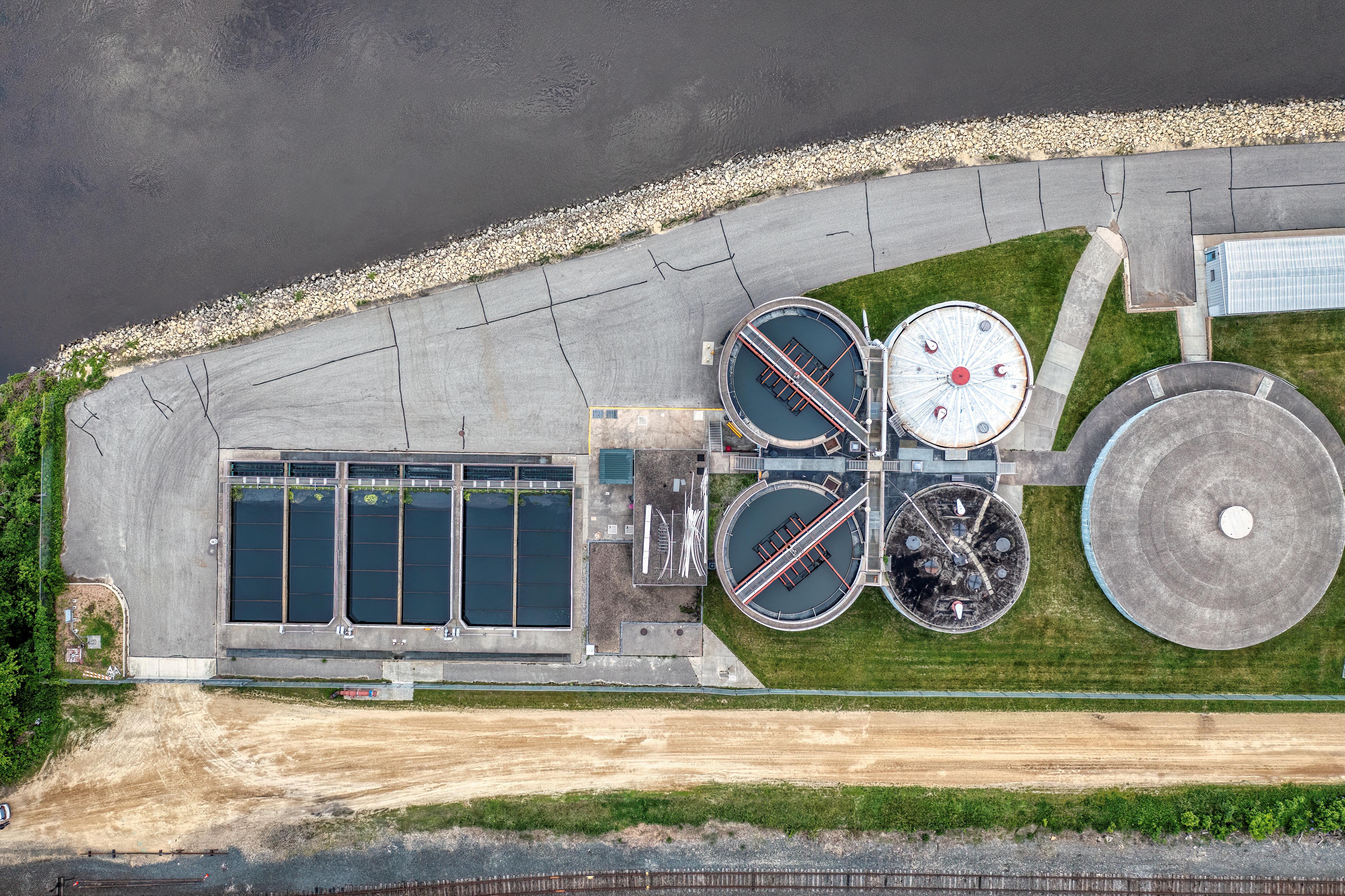 Top-down aerial view of a water treatment plant in Red Wing, MN near a river.