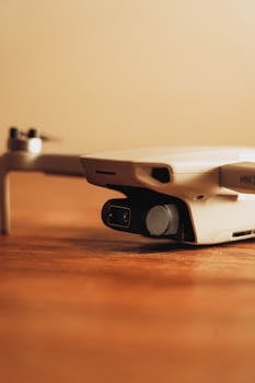 A detailed close-up of a drone resting on a wooden surface.