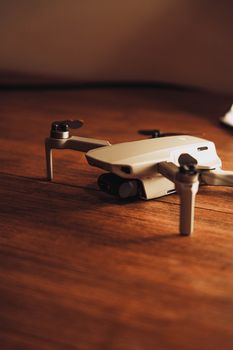 Detailed view of a DJI Mavic Mini 2 drone resting on a wooden surface, showcasing modern technology.