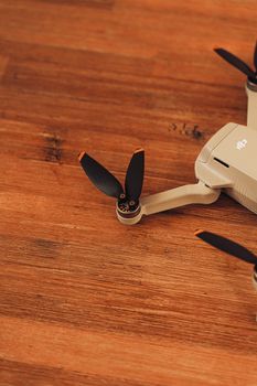 Detailed close-up image of a drone propeller resting on a wooden surface. Ideal for tech themes.