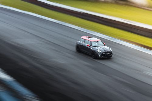 Free Mini Cooper driving fast on a race track in Curitiba, Brazil showcasing speed and precision. Stock Photo