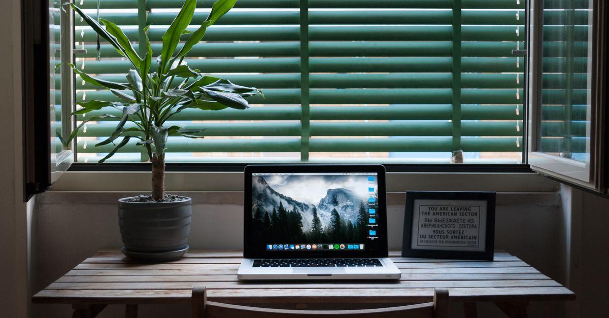 cozy home office with laptop and coffee, auto-blog configuration setup