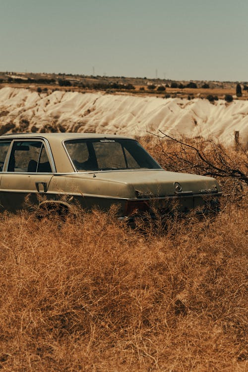 An Abandoned Car Parked on the Field