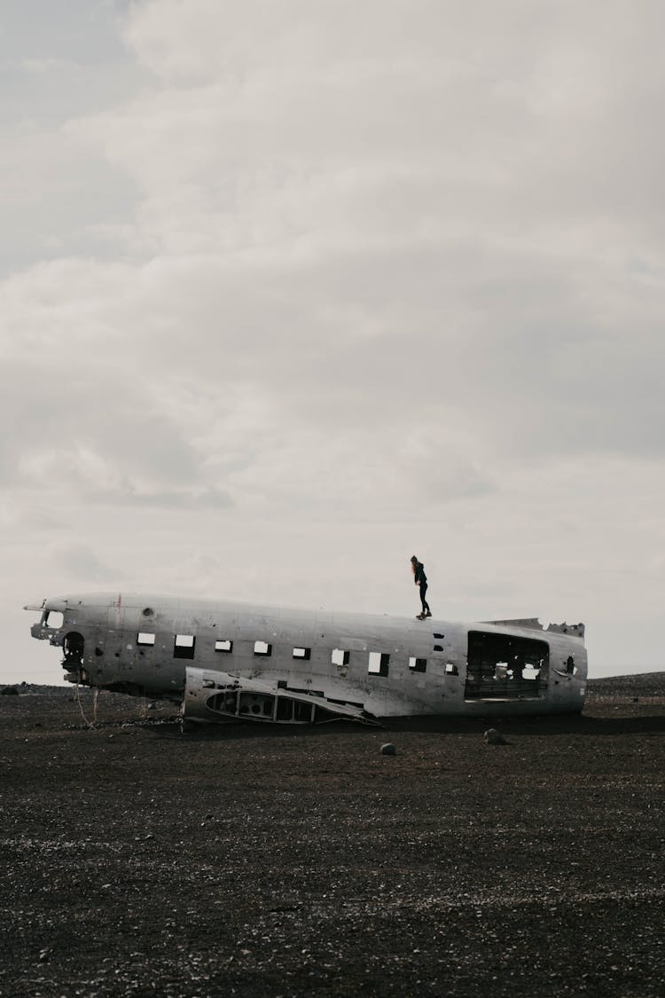 Person Walking On Top Of A Airplane Wreck