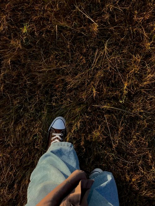 Free Aerial view of a person walking through grassy fields in Van, Turkey, wearing casual sneakers. Stock Photo
