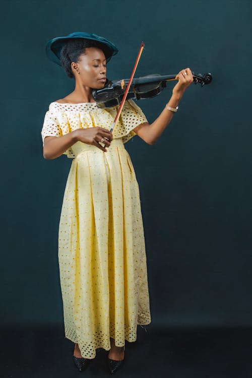 Woman in Yellow Dress Playing Violin