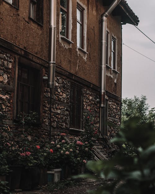 Dark Photograph of a Brown House with Stone Decoration