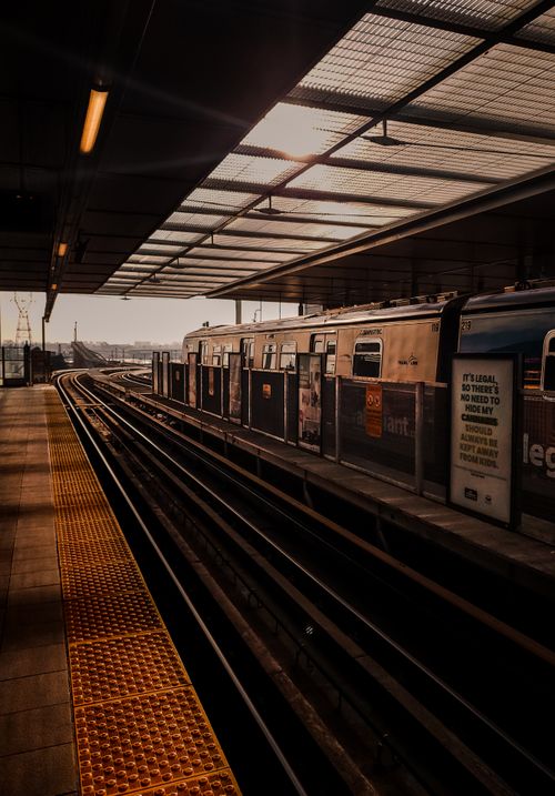 Free Passenger train at an urban railway station platform in Vancouver during sunset. Stock Photo