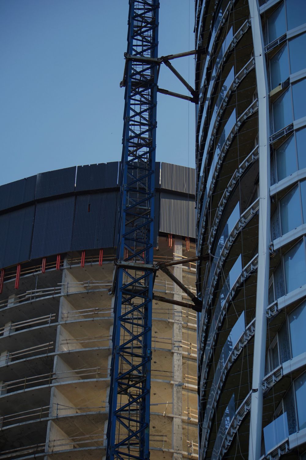 Modern high-rise building under construction, glass and steel facade