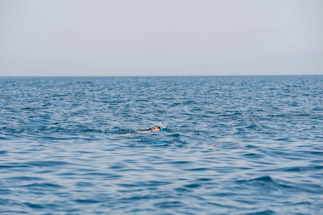 Person Swimming on Ocean 