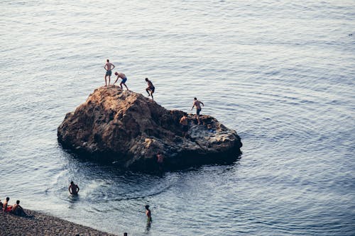 People Standing on Rock Formation 