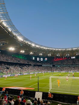 A thrilling football match with packed stands at FC Krasnodar's iconic stadium.