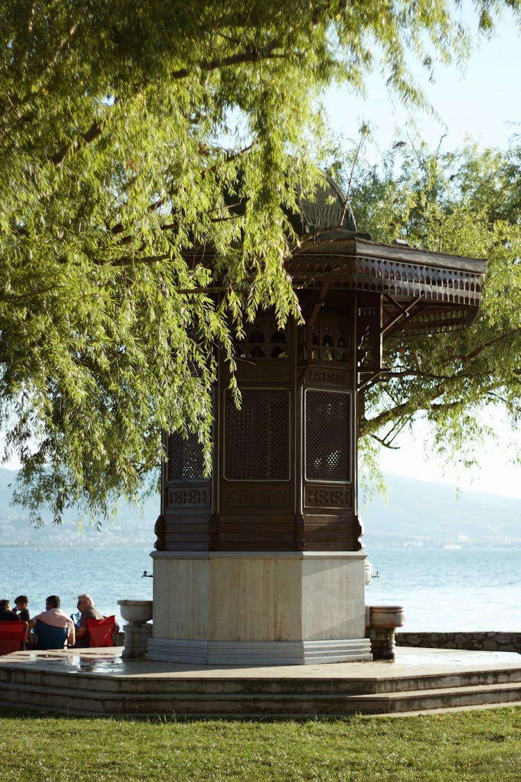 People Sitting Beside The Gazebo