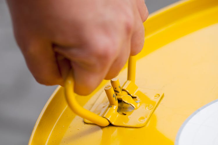 A Person Holding Yellow Barrel