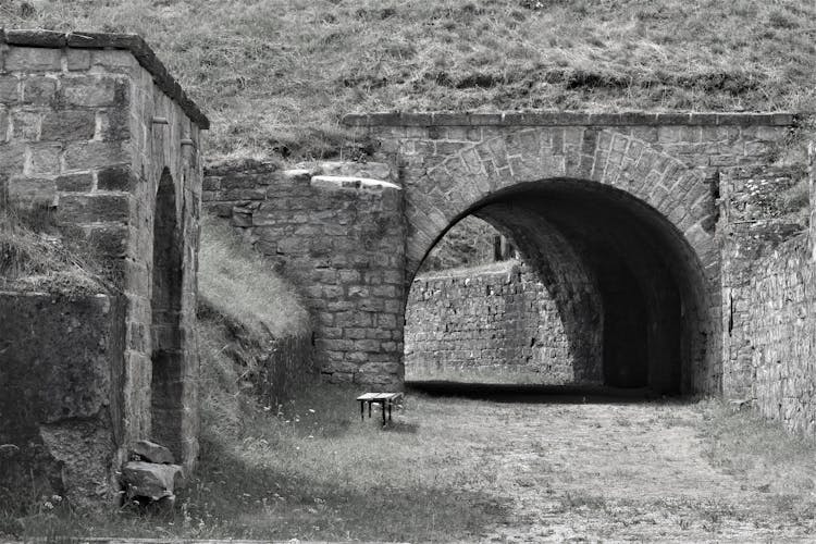 Grayscale Photo Of A Tunnel