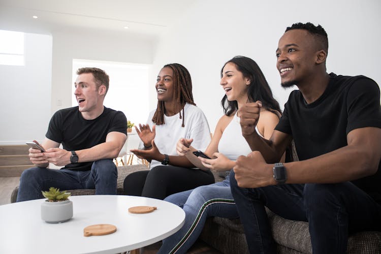 Friends Cheering While Watching TV