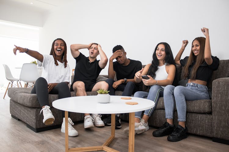 Friends Cheering While Watching Sports