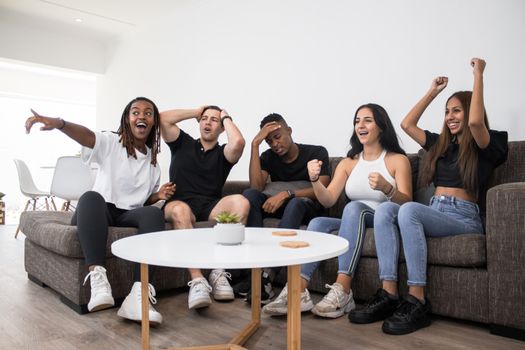 Group of Friends Enthusiastically Watching TV 