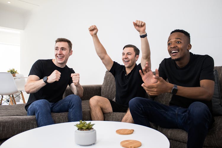 Friends Cheering While Watching Sports