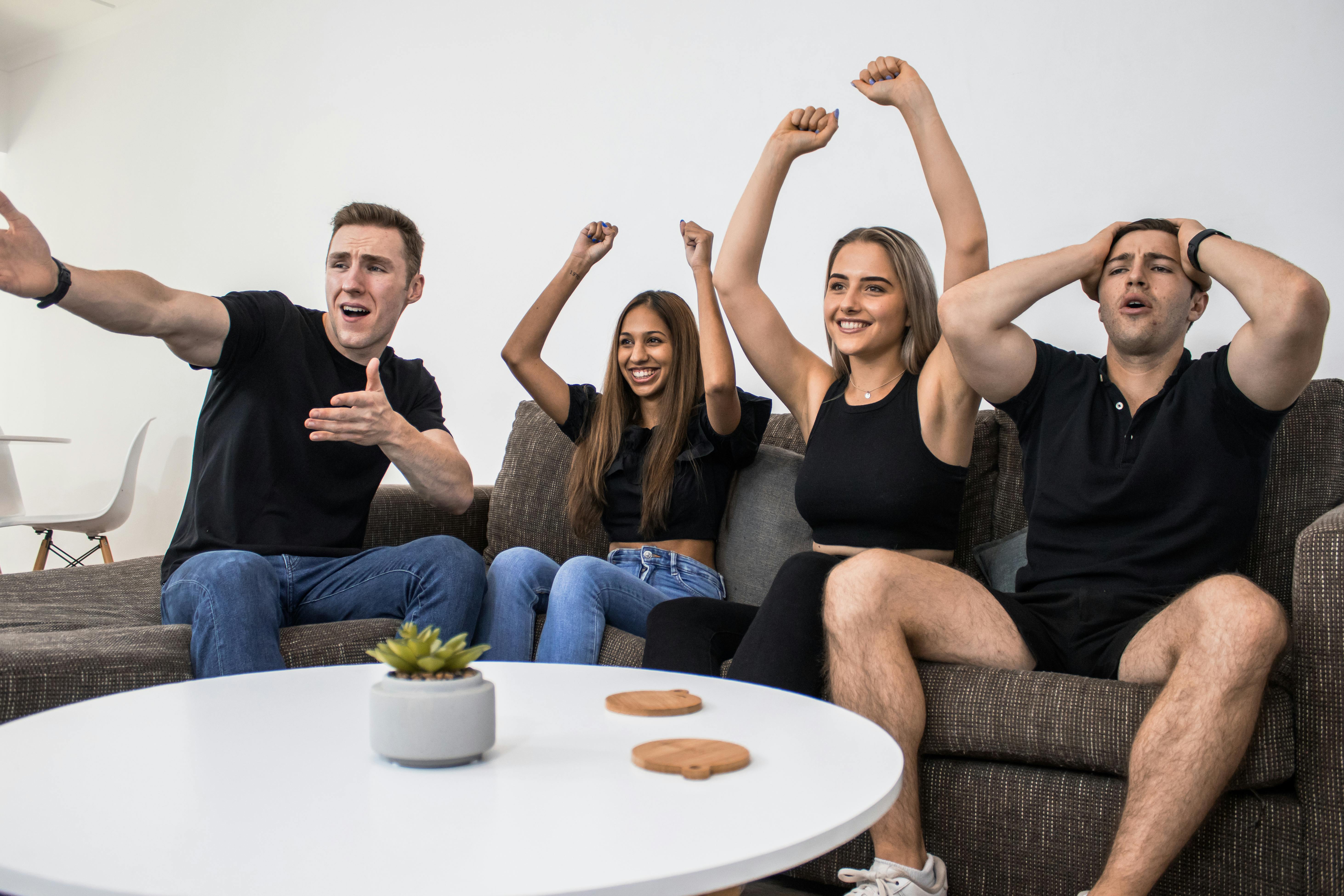 group cheering watching sports on tv