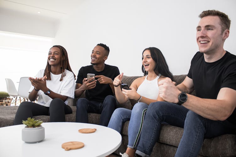 Group Of Friends Watching TV Together