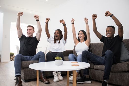 Friends Cheering in Unison while Watching Sports
